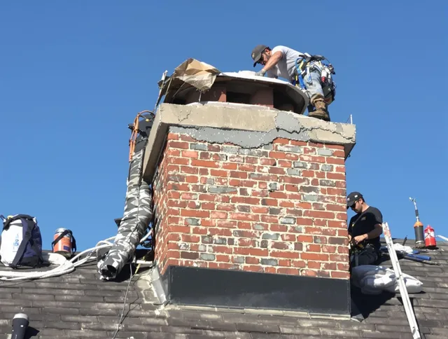 Newtown Chimney Sweep installing a custom chimney crown in Newtown, CT