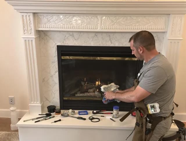 Newtown Chimney Sweep performing fireplace maintenance in Newtown, CT