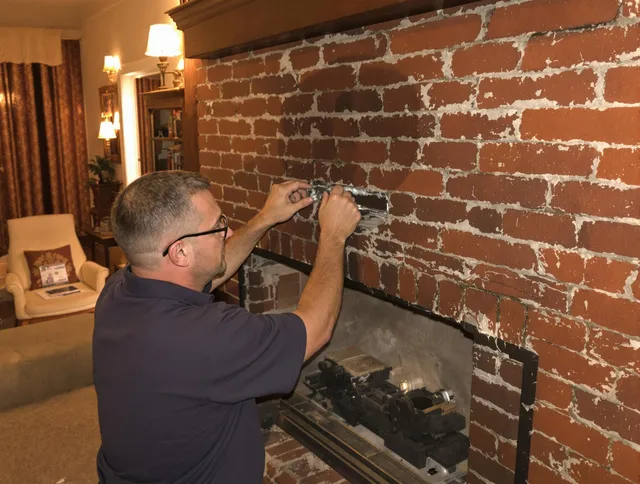 Newtown Chimney Sweep expert fixing a fireplace in Newtown, CT
